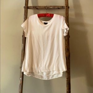 Off white short sleeved sweater with open back.